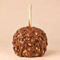 A Snickers Caramel Apple covered with milk chocolate. Made by Morkes Chocolates.
